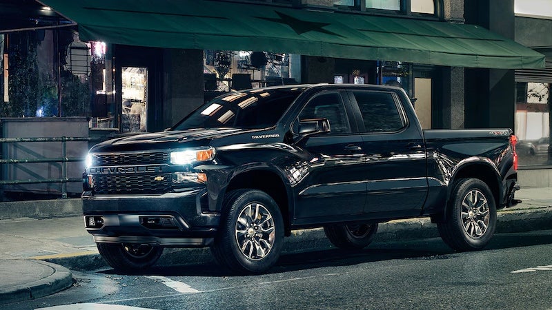 black 2019 Chevrolet Silverado with headlights on