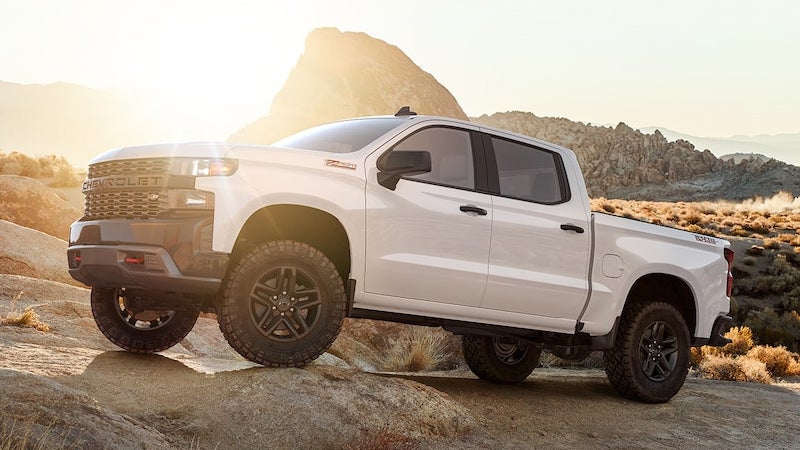 white 2019 Chevrolet Silverado parked on rocks