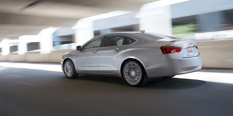 Silver 2020 Chevrolet Impala driving on roadway