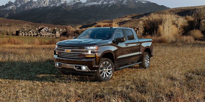 Black 2020 Chevrolet Silverado 1500 parked in field with mountains behind