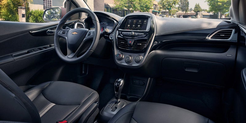 Interior view of driver's seat, steering wheel and dashboard in a 2020 Chevrolet Spark