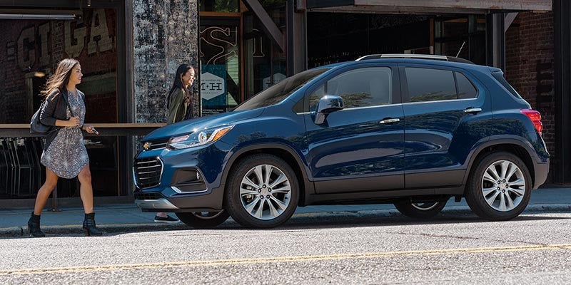 2020 Chevrolet Trax parked on street with girl walking towards it