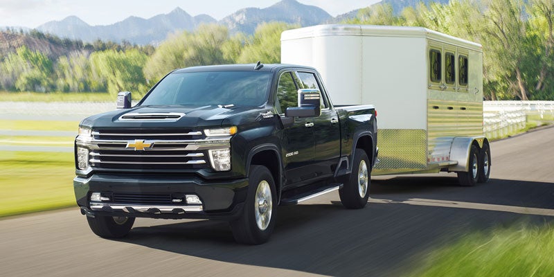 2021 Chevrolet Silverado 2500 HD towing a trailer while driving