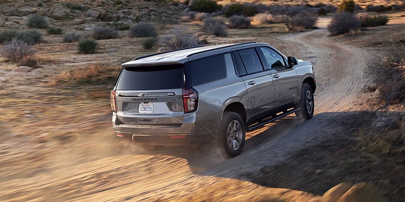 2021 Chevrolet Suburban driving on unpaved dirt road