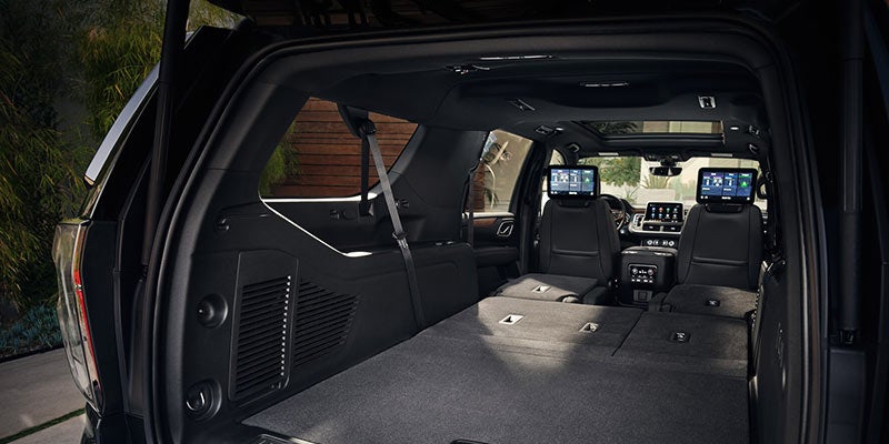 Inside a2021 Chevrolet Suburban with backseats down to show off interior space