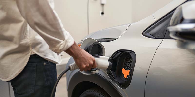 Person charging a 2022 Chevrolet Bolt EUV