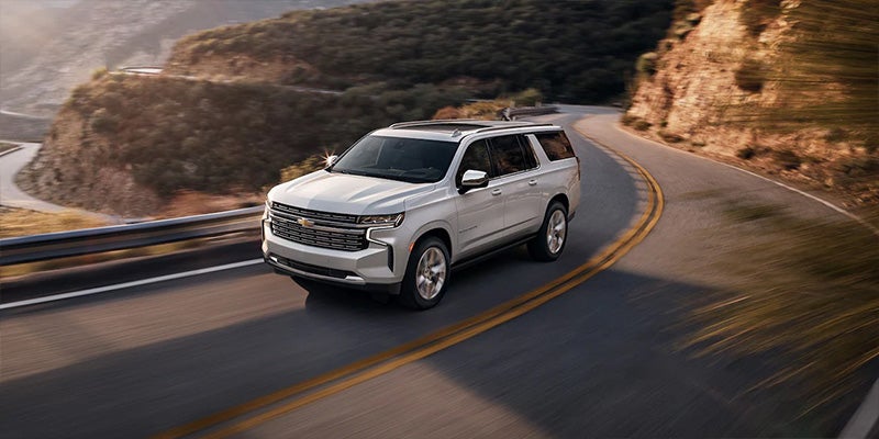 White 2022 Chevrolet Suburban driving up mountain