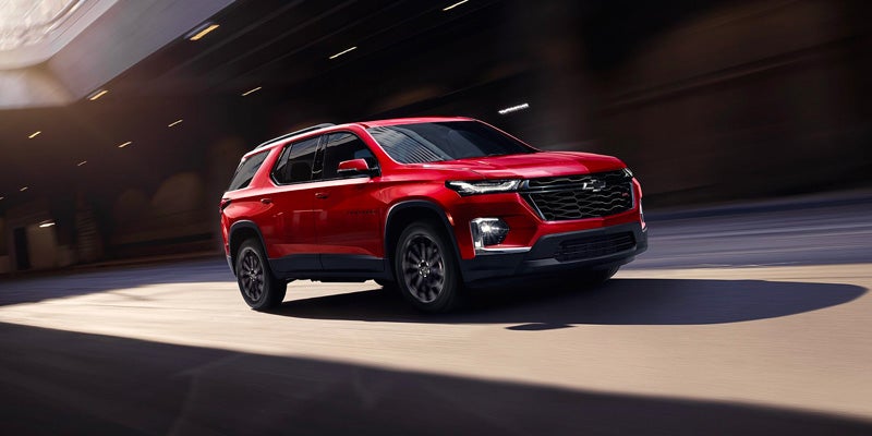 Red 2023 Chevy Traverse driving fast on road