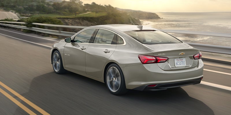 2024 Chevrolet Malibu driving on road by the sea