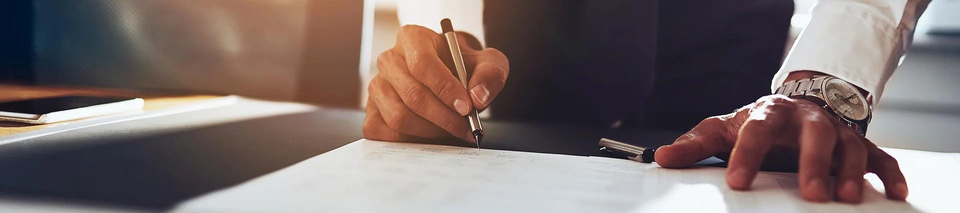 Man signing finance papers