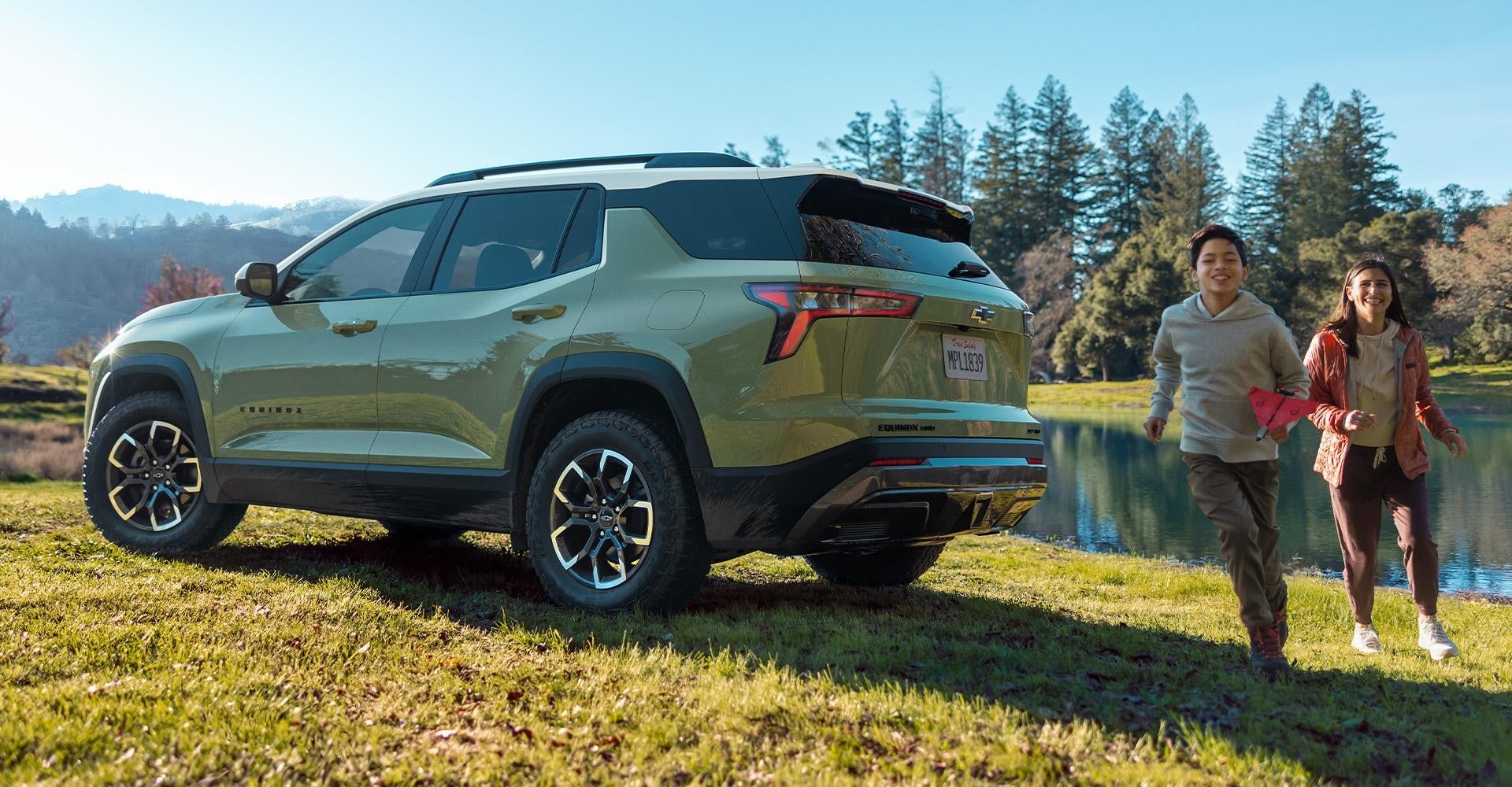 Green Chevy Equinox in Blue parked by a lake