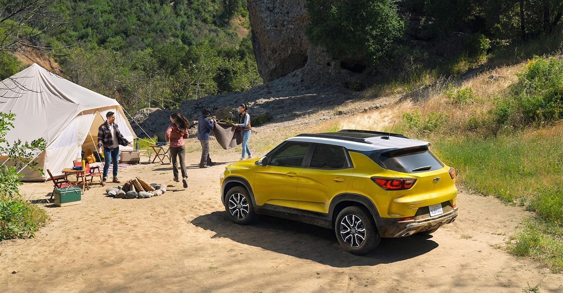 People camping around a Chevy Trailblazer