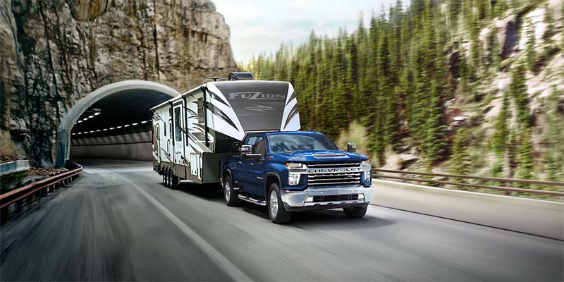 2022 Chevrolet Silverado LTD driving while towing large camper